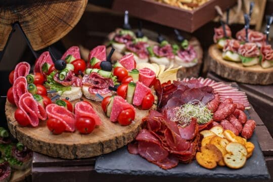 Food at event. Assorted Canapés on Rustic Wooden Platter